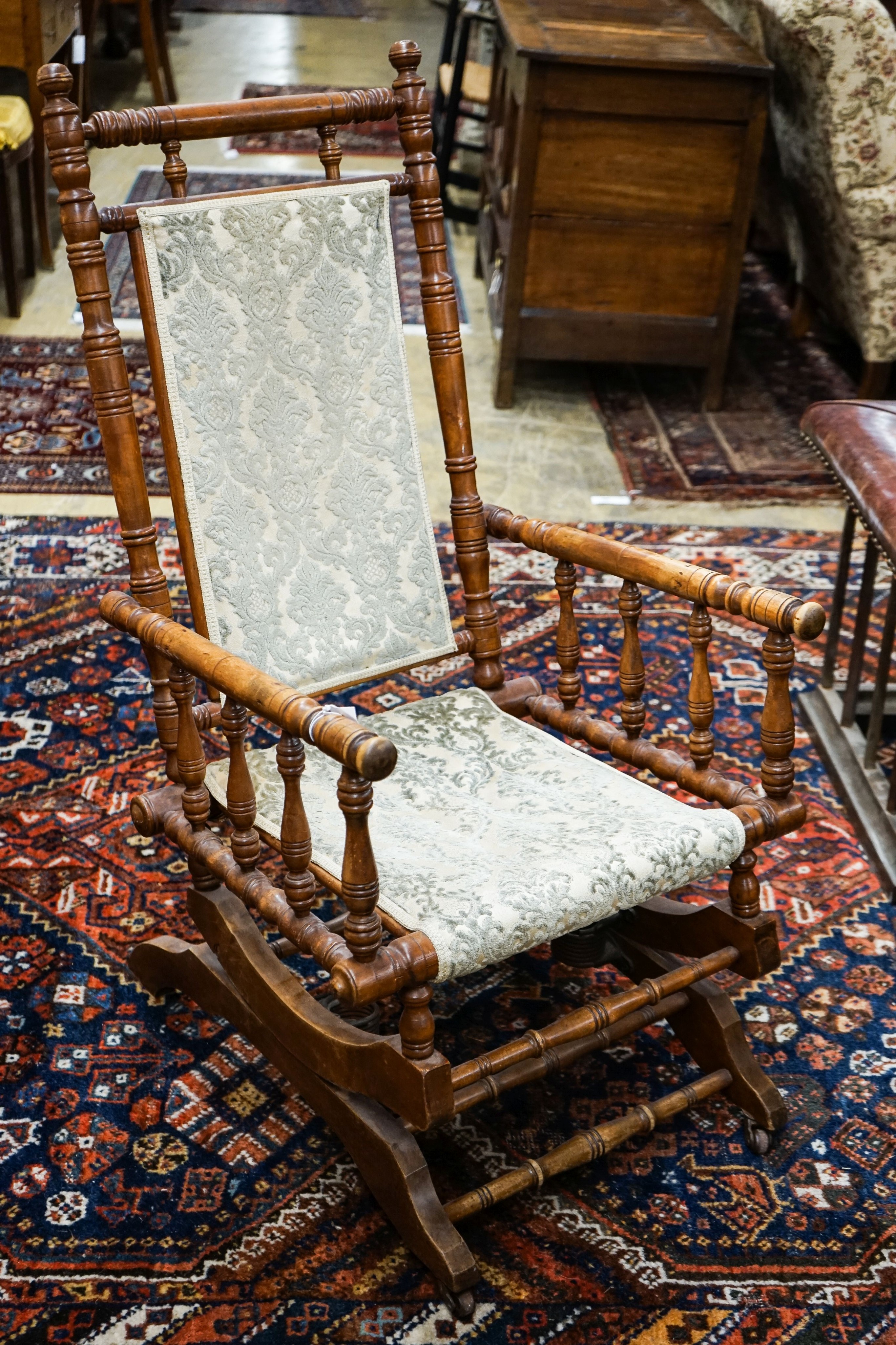 An early 20th century American rocking chair, width 54cm, depth 50cm, height 106cm